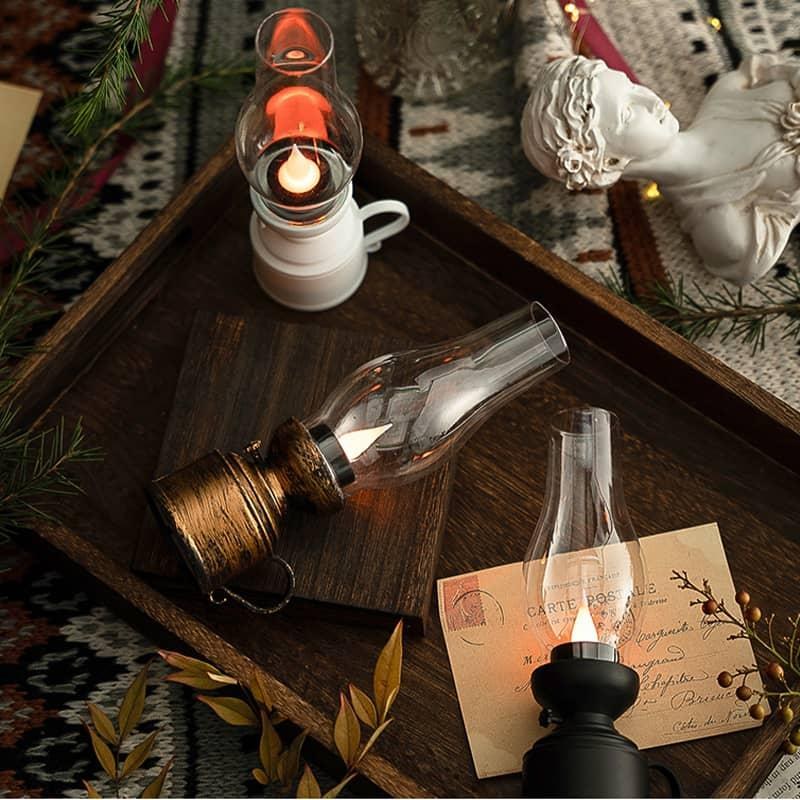 Top-down view of three oil lamps on wooden tray with decor