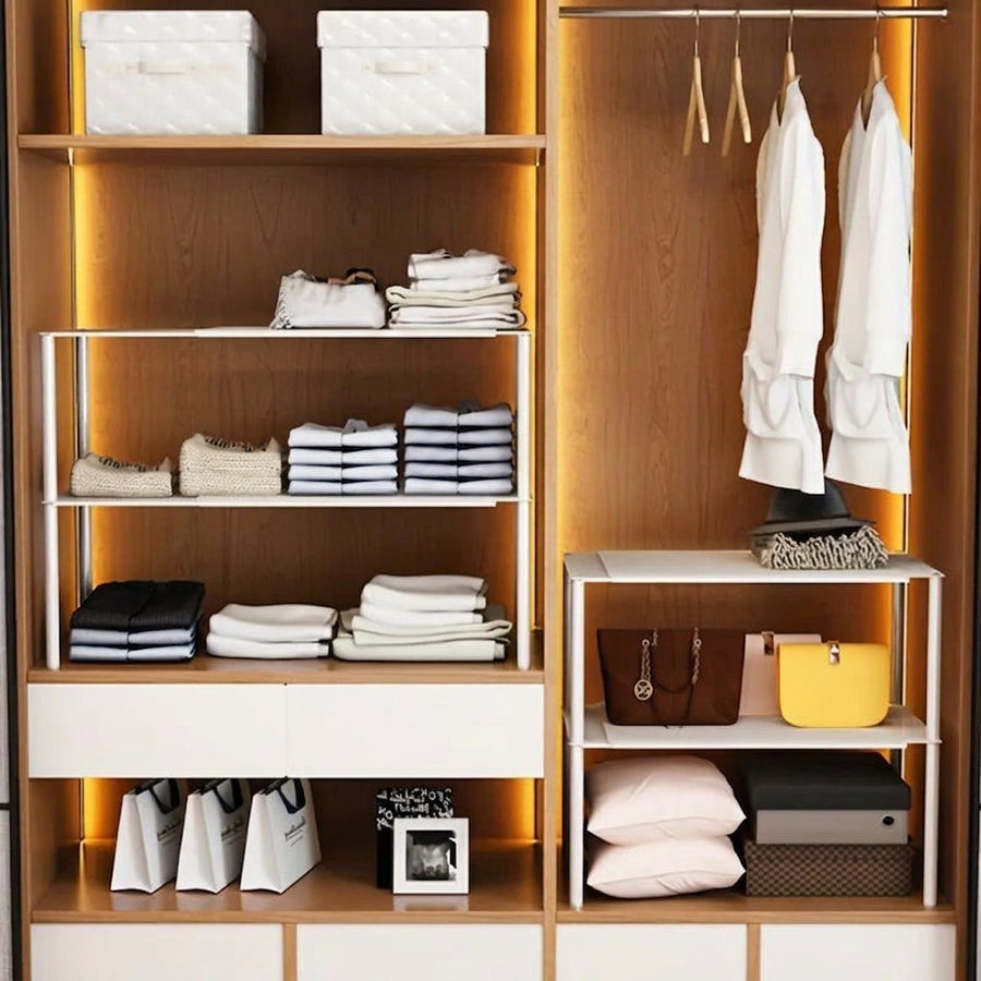 Large closet with expandable shelves and neatly organized clothing