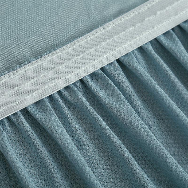 Elastic ruffle hem detail showing skirt seam and non-slip construction