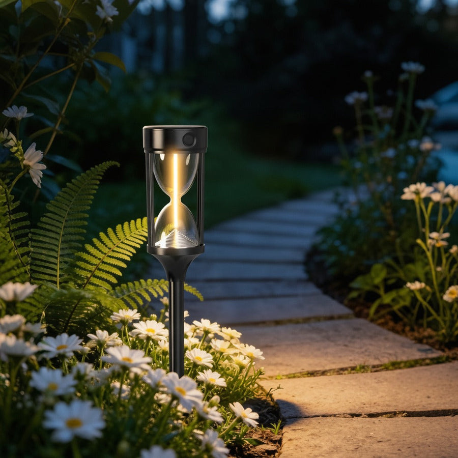 Solar light along a garden path lined with daisies