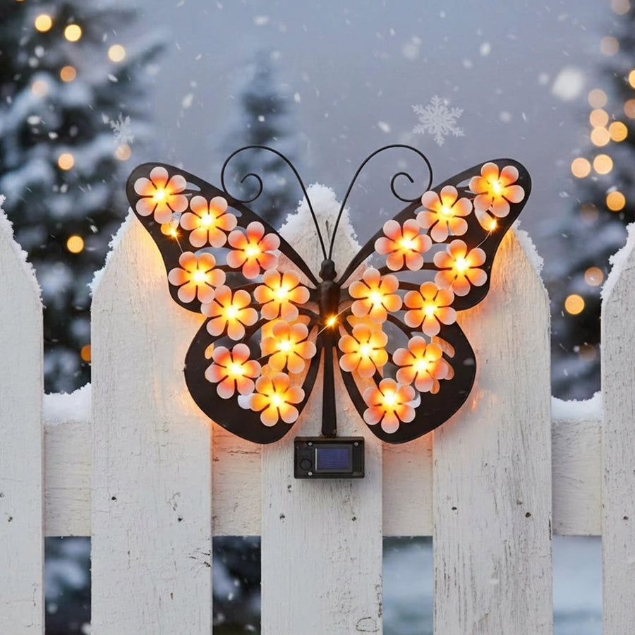 Solar butterfly on a fence in the snow – winter decor