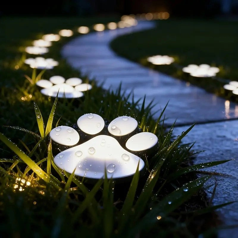 Paw light with water droplets showing its waterproof design, lit pathway
