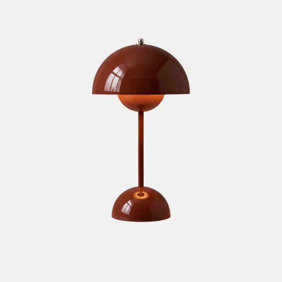 Red table lamp with dome shade on a neutral background