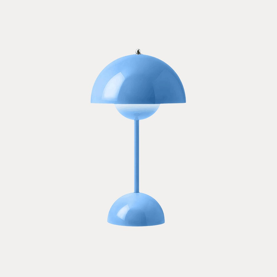 Blue table lamp with dome shade on a neutral background
