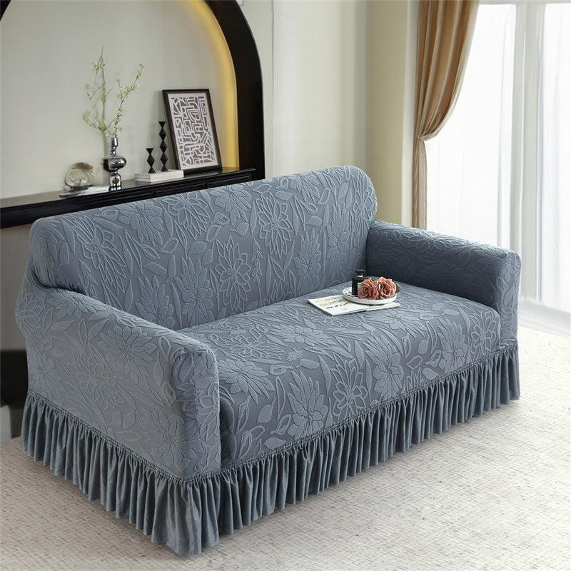 Light gray sofa slipcover with embossed jacquard and ruffle