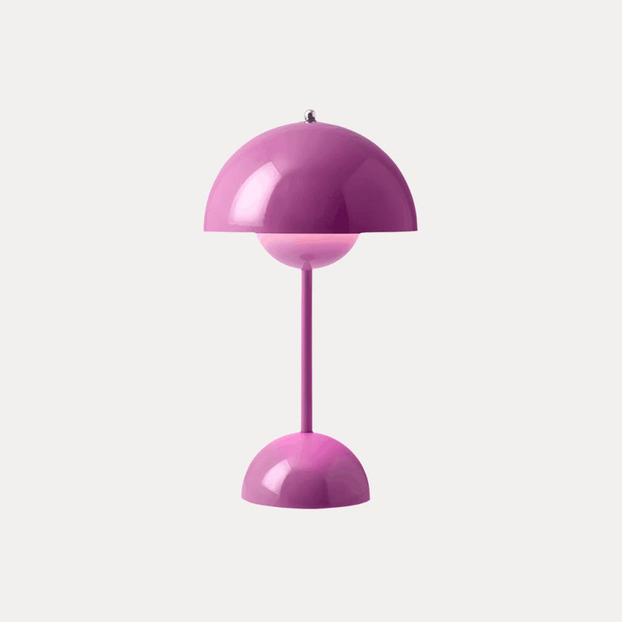 Pink table lamp with dome shade on a neutral background