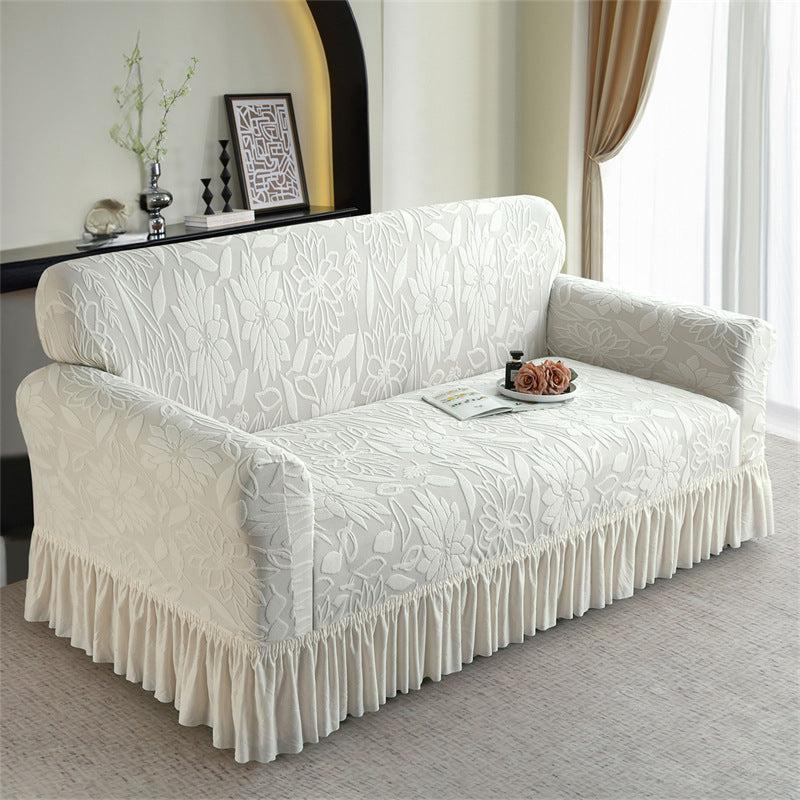 Beige sofa slipcover with floral jacquard pattern and ruffled base