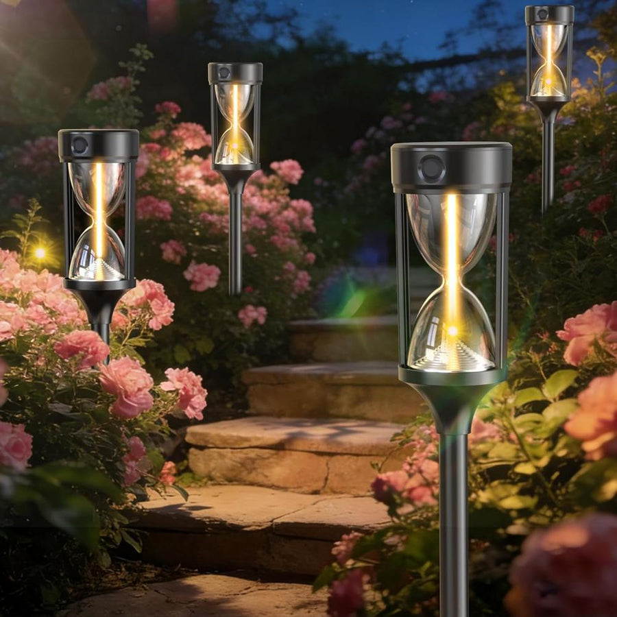 Hourglass solar lights placed among roses in the garden
