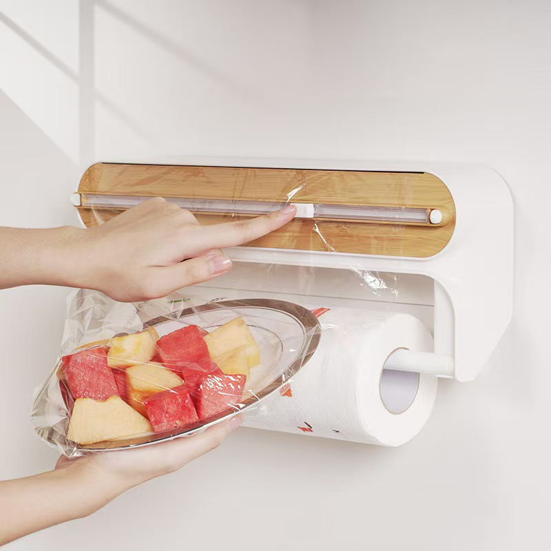 Wrap dispenser with towel holder attachment holding a paper towel roll