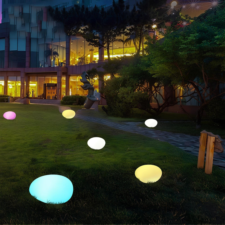 Colorful stone-shaped LED garden lamps on the lawn