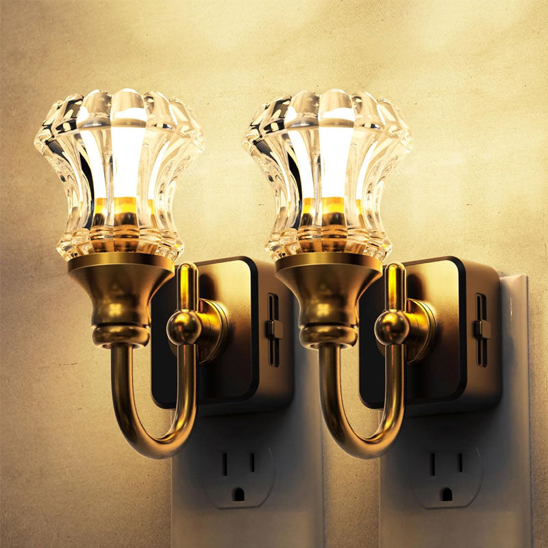 Two vintage brass wall sconces with glass shades side by side