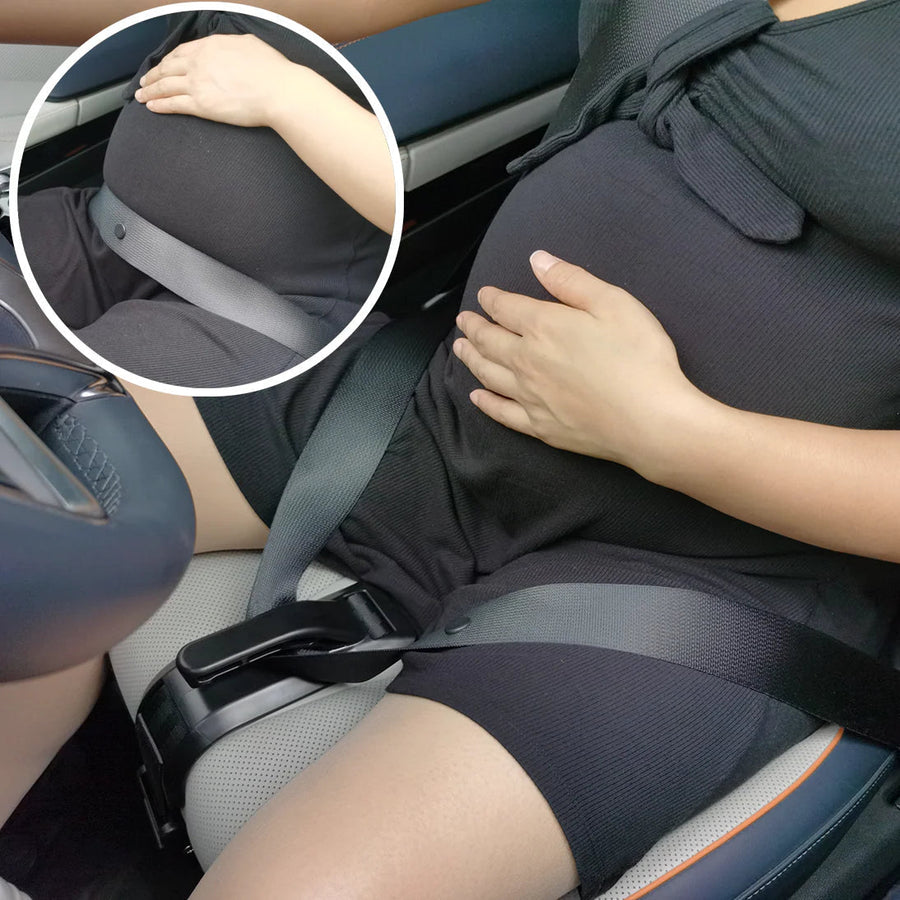 Pregnant woman with the seat belt positioned below her belly in the car