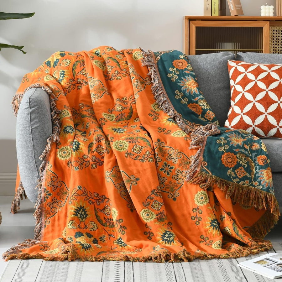 Marigold reversible throw blanket draped on a bed