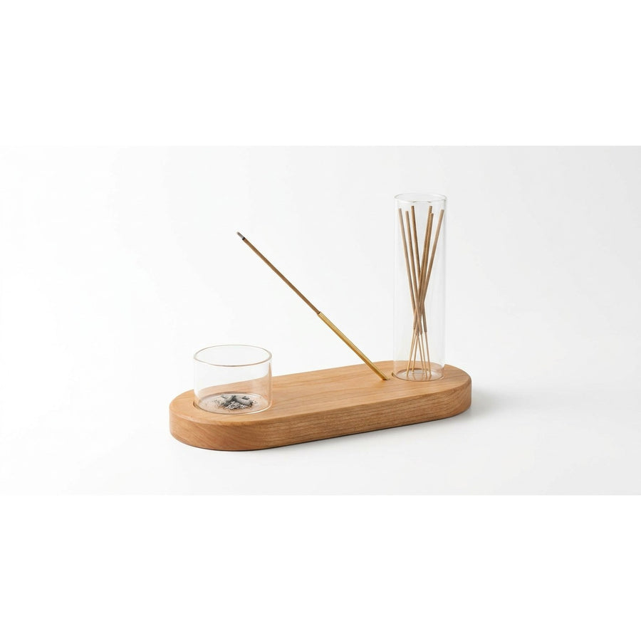 Incense holder set on white background showing wooden base, glass cylinders, and brass arm