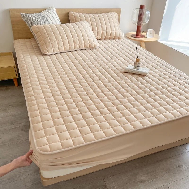 Quilted mattress cover fitted over a mattress corner