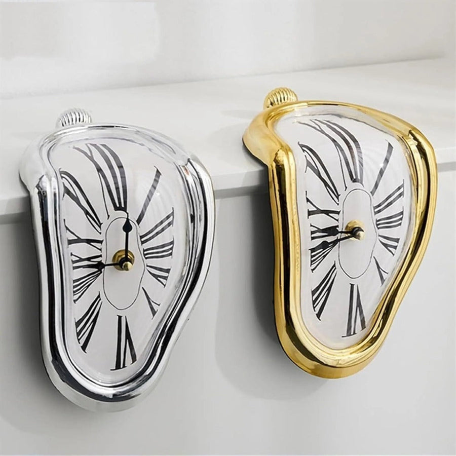Silver and gold melting decorative clocks shown side by side.