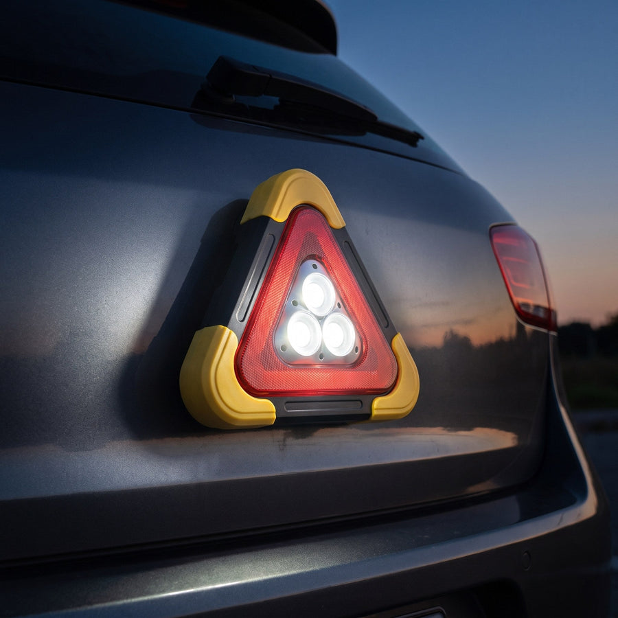 Emergency beacon attached with a magnet to a trunk lid in work light mode