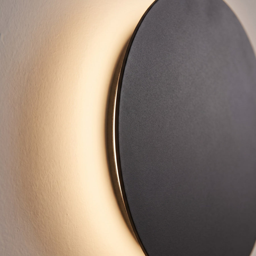 Close-up of the lamp's matte surface and soft light glowing behind the disc