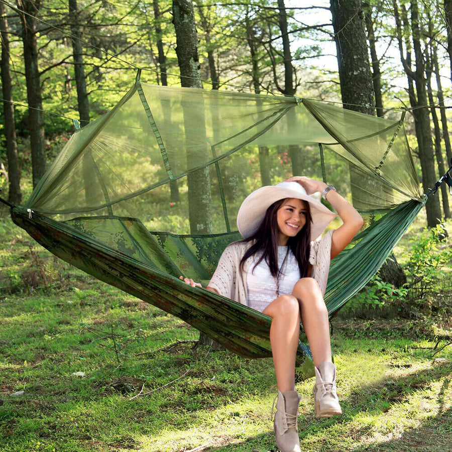 Two-person camping hammock with tent set up outdoors