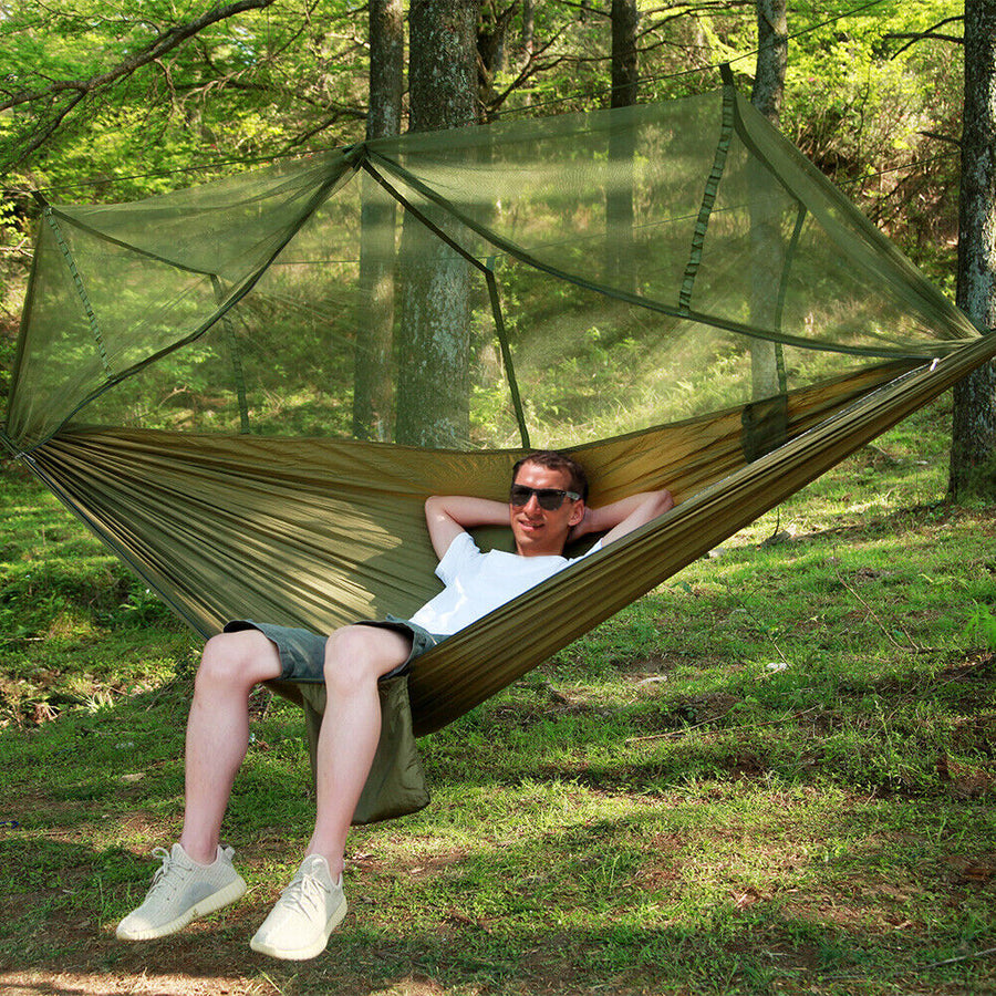 Camping hammock with tent hung between trees
