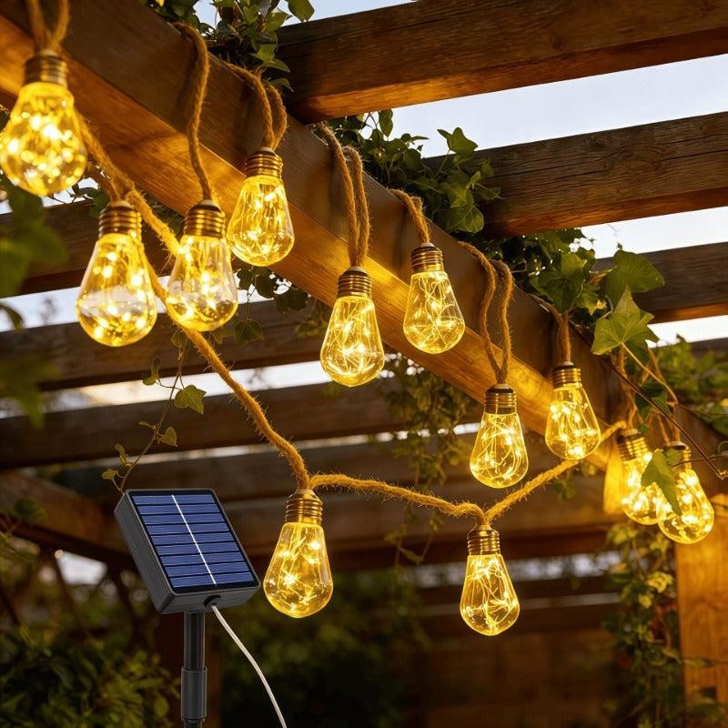 Solar hemp rope string lights on a pergola with the solar panel in the foreground