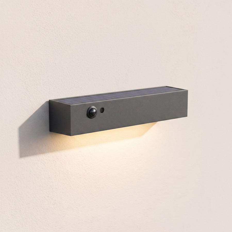 Solar wall light in daylight showing solar panel and motion sensor
