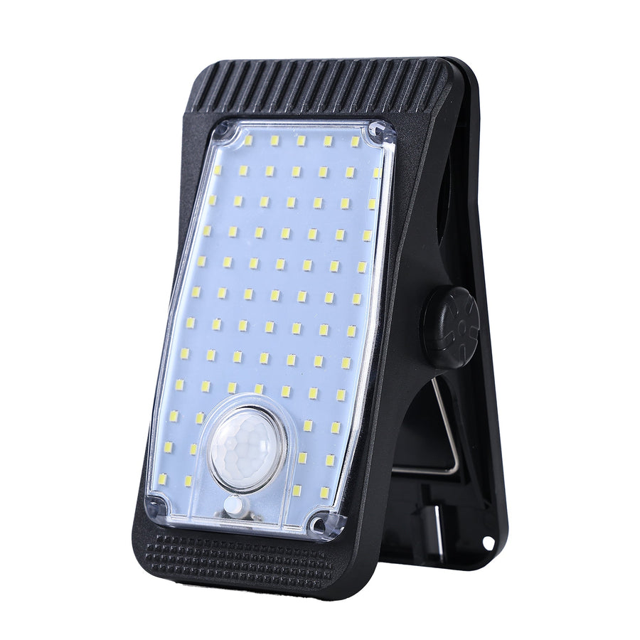 Solar light with clip mount on white background, LED and motion sensor visible