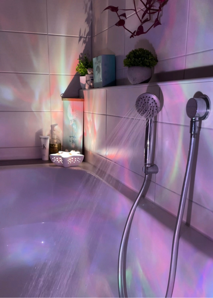 Starfish lamp projecting rainbow wave patterns in bathroom