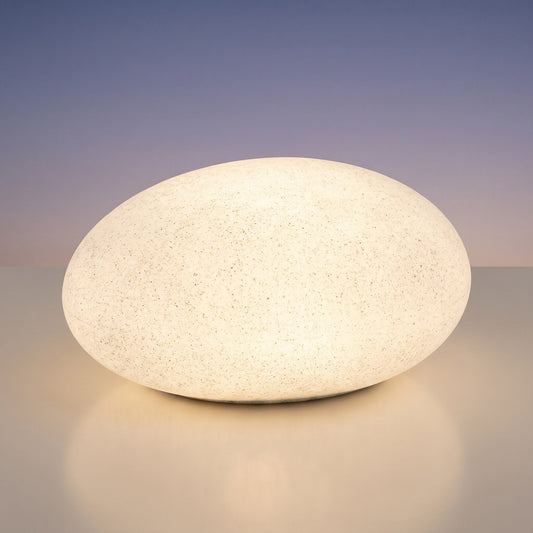 Stone-shaped LED garden lamp glowing warm white