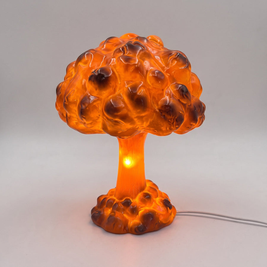 Mushroom cloud LED table lamp in glossy orange resin, lit