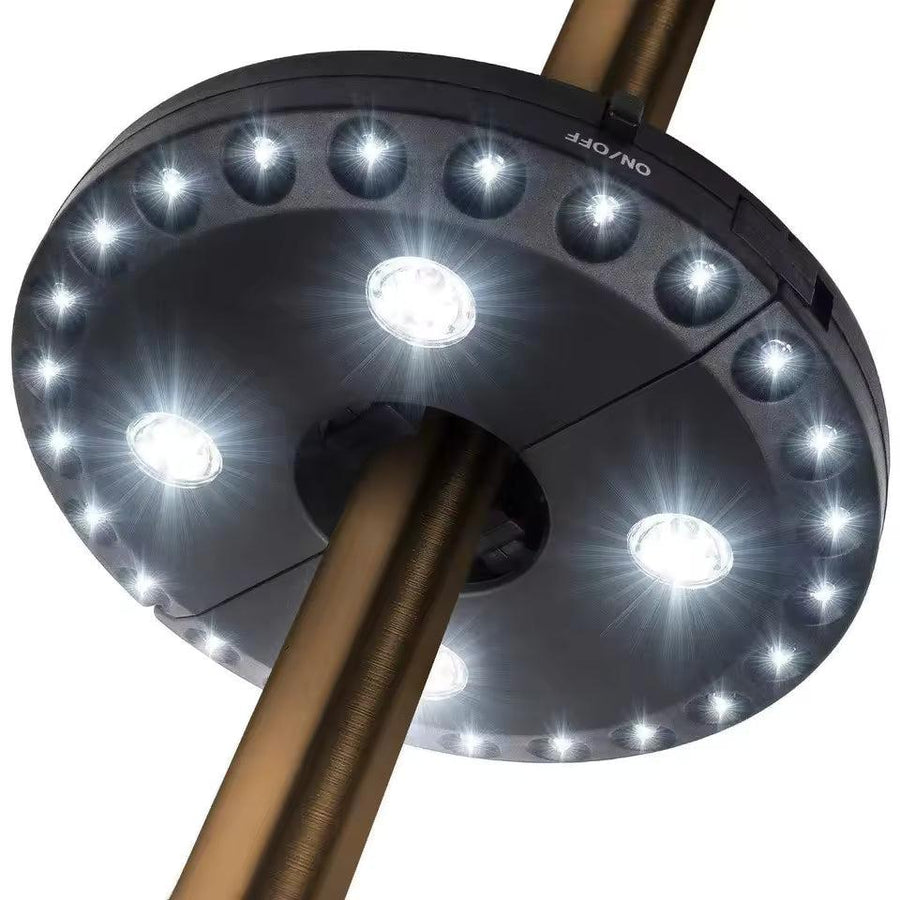 LED light clipped onto a patio umbrella pole, illuminated