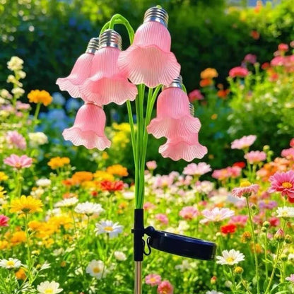 Pink solar flower stake lights in colorful garden