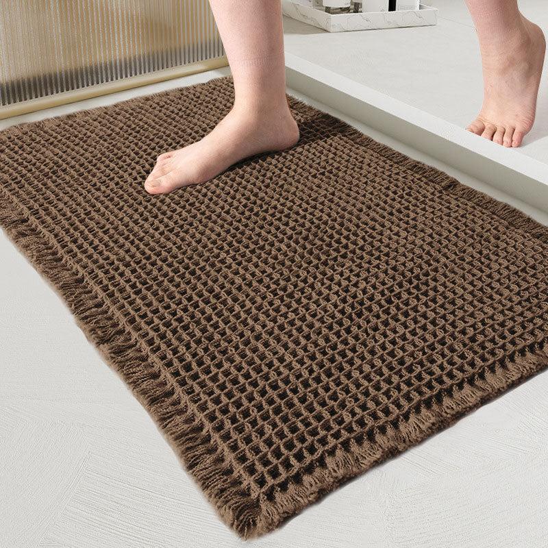 Brown waffle-weave bath mat with fringed edges