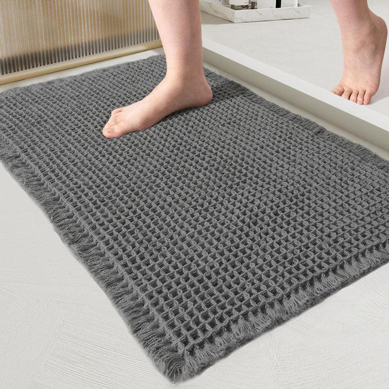 Charcoal waffle-weave bath mat with fringed edges